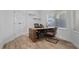 Office space featuring a natural wood desk, wood floors, and a large window at 7627 Boca Raton Dr, Las Vegas, NV 89113