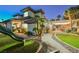 Expansive backyard featuring a play area, pool with waterfall, plus a covered patio with string lights at 764 Ricota Ct, Henderson, NV 89012