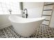 Modern bathroom featuring a standalone tub, unique fixtures, and decorative ladder at 764 Ricota Ct, Henderson, NV 89012