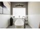 Modern bathroom features a freestanding tub, patterned tile floor, and decorative accents at 764 Ricota Ct, Henderson, NV 89012