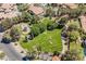 Overhead view of a well-maintained community park featuring lush green spaces and a colorful playground at 764 Ricota Ct, Henderson, NV 89012