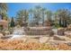 Landmark entrance to Roma Hills with a stone waterfall feature, manicured landscaping, and clear blue skies at 764 Ricota Ct, Henderson, NV 89012