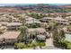 Stunning aerial view of the grand home with manicured landscaping and a tennis court in a desirable neighborhood at 764 Ricota Ct, Henderson, NV 89012