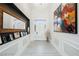 Elegant foyer with a chandelier, modern artwork, and a decorative mirror at 764 Ricota Ct, Henderson, NV 89012