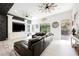 Inviting living room with large windows, a media center, and a comfortable leather sofa at 764 Ricota Ct, Henderson, NV 89012