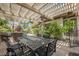 Inviting outdoor patio features a dining table, grill, and lush landscaping for relaxing and entertaining at 764 Ricota Ct, Henderson, NV 89012