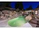 Backyard pool featuring rock waterfall and covered outdoor dining area at 764 Ricota Ct, Henderson, NV 89012