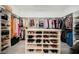 Walk-in closet with custom shelving and ample storage for shoes and clothing at 764 Ricota Ct, Henderson, NV 89012