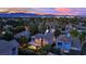 Beautiful aerial view of a home at dusk nestled in a lush neighborhood with mountain views at 7837 Sea Rock Rd, Las Vegas, NV 89128