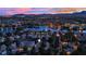 An aerial view of a home in a lakeside community at dusk, showcasing scenic views at 7837 Sea Rock Rd, Las Vegas, NV 89128