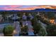 Sunset aerial view of a residential area showcasing tile roofs, mature trees, and well-maintained properties at 7837 Sea Rock Rd, Las Vegas, NV 89128