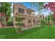 Large backyard featuring a covered patio and a lush, green lawn at 7837 Sea Rock Rd, Las Vegas, NV 89128