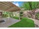 Expansive backyard with covered patio, lush lawn, and mature trees, perfect for outdoor entertaining at 7837 Sea Rock Rd, Las Vegas, NV 89128