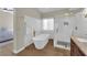 Modern bathroom featuring standalone tub, walk-in shower and unique tiling at 7837 Sea Rock Rd, Las Vegas, NV 89128