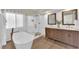 Bright bathroom featuring a soaking tub, walk-in shower, and a double sink vanity at 7837 Sea Rock Rd, Las Vegas, NV 89128