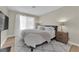 Comfortable bedroom features a bed, plush rug, and natural light from the windows at 7837 Sea Rock Rd, Las Vegas, NV 89128