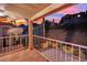 Relaxing covered patio with tiled floors and wrought iron railing, offering views of the neighborhood and sky at 7837 Sea Rock Rd, Las Vegas, NV 89128