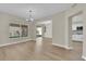 A dining room with hardwood floors, a chandelier, and access to the backyard at 7837 Sea Rock Rd, Las Vegas, NV 89128