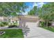 Charming home with lush landscaping, a well-maintained lawn, and a two-car garage at 7837 Sea Rock Rd, Las Vegas, NV 89128