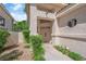 Inviting front entrance featuring a pathway, manicured bushes, and a stucco facade at 7837 Sea Rock Rd, Las Vegas, NV 89128