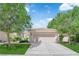 Attractive home exterior with green lawn, mature shade trees, and attached garage at 7837 Sea Rock Rd, Las Vegas, NV 89128