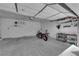 Spacious garage with overhead storage, motorcycle, and ample room for vehicles at 7837 Sea Rock Rd, Las Vegas, NV 89128
