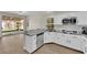 Charming kitchen showcasing stainless steel appliances, granite counters, breakfast bar, and direct access to the outdoor patio at 7837 Sea Rock Rd, Las Vegas, NV 89128