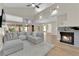 Cozy living room featuring a comfortable sectional sofa and fireplace with stone surround at 7837 Sea Rock Rd, Las Vegas, NV 89128