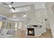 Open living area with fireplace, ceiling fans, and staircase at 7837 Sea Rock Rd, Las Vegas, NV 89128