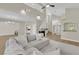 Open-concept living room featuring high ceilings, fireplace, and a comfortable sectional sofa at 7837 Sea Rock Rd, Las Vegas, NV 89128