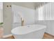 Elegant main bathroom showcasing a freestanding tub, modern fixtures and ample natural light at 7837 Sea Rock Rd, Las Vegas, NV 89128