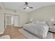 Bright bedroom features neutral tones, ceiling fan and wood-look flooring at 7837 Sea Rock Rd, Las Vegas, NV 89128