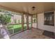 Enclosed patio with tile flooring, bright sunlight, and access to landscaped backyard at 7837 Sea Rock Rd, Las Vegas, NV 89128