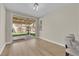 Bright sunroom with hardwood floors, a sliding glass door, and backyard views at 7837 Sea Rock Rd, Las Vegas, NV 89128