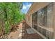 Side yard with a stone walkway, low-maintenance landscaping, and a view of the home's exterior at 7837 Sea Rock Rd, Las Vegas, NV 89128