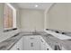 Elegant wet bar features white cabinetry and stone countertops, perfect for entertaining guests at 7837 Sea Rock Rd, Las Vegas, NV 89128