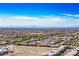 An aerial view of a neighborhood with mountains in the distance on a sunny day at 7990 Formitch Ct, Las Vegas, NV 89166