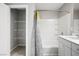 Bright bathroom featuring a shower-tub, white vanity, and shelving at 7990 Formitch Ct, Las Vegas, NV 89166