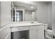 Bathroom with white vanity, large mirror, and toilet is simple and stylish at 7990 Formitch Ct, Las Vegas, NV 89166
