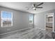 Bedroom featuring a view from its bright windows, wood-look flooring, and ceiling fan at 7990 Formitch Ct, Las Vegas, NV 89166