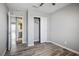 Bedroom with wood-look floors, adjacent bathroom and closet at 7990 Formitch Ct, Las Vegas, NV 89166