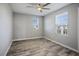 Bedroom featuring bright windows, wood-look flooring, and a ceiling fan at 7990 Formitch Ct, Las Vegas, NV 89166