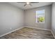 Bedroom featuring wood-look floors, ceiling fan, and window for natural light at 7990 Formitch Ct, Las Vegas, NV 89166
