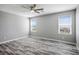 A modern, light-filled bedroom features wood-look flooring and bright windows at 7990 Formitch Ct, Las Vegas, NV 89166