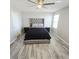 Bedroom featuring a ceiling fan, plush upholstered headboard, and wood-look flooring at 7990 Formitch Ct, Las Vegas, NV 89166
