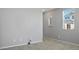 Empty bedroom featuring tile floors, a window with blinds, and gray walls at 7990 Formitch Ct, Las Vegas, NV 89166