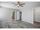 A bedroom featuring wood-look flooring, a ceiling fan, and multiple doorways at 7990 Formitch Ct, Las Vegas, NV 89166