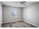 Light-filled bedroom features wood-look flooring, a window, and neutral gray paint at 7990 Formitch Ct, Las Vegas, NV 89166