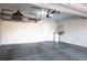 Garage featuring concrete flooring, storage rack, water heater, and door to interior at 7990 Formitch Ct, Las Vegas, NV 89166