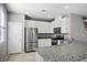 Modern kitchen with stainless appliances, white cabinets, and granite countertops at 7990 Formitch Ct, Las Vegas, NV 89166